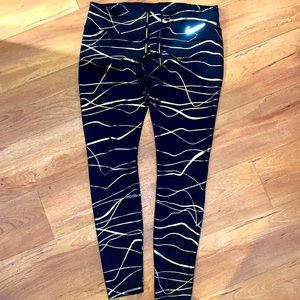 Women’s size large black and gold Nike Running leggings.